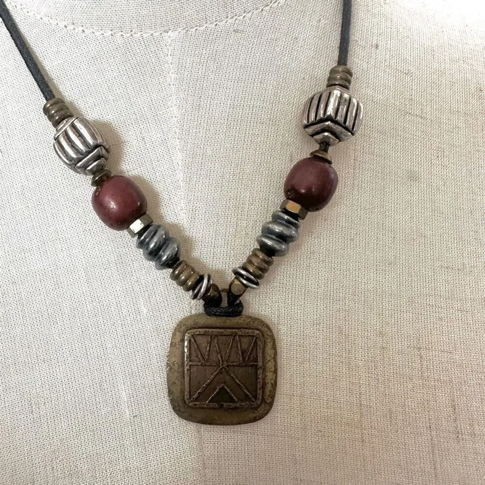 Baer SF sterling silver and brass pendant necklace on black cord